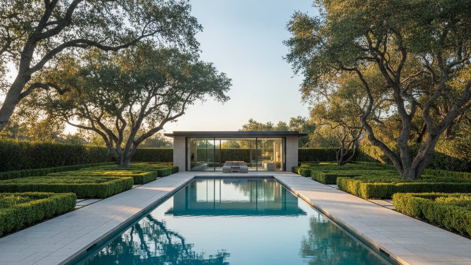 Concept study: an Atherton backyard at golden hour with a long rectangular pool, clipped hedges, mature oaks and a glass-walled pool house