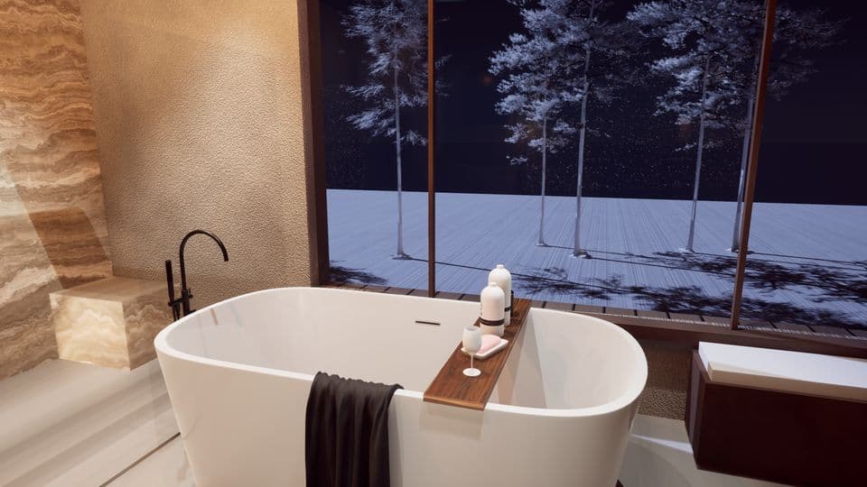 A freestanding tub against a panoramic window onto the snow