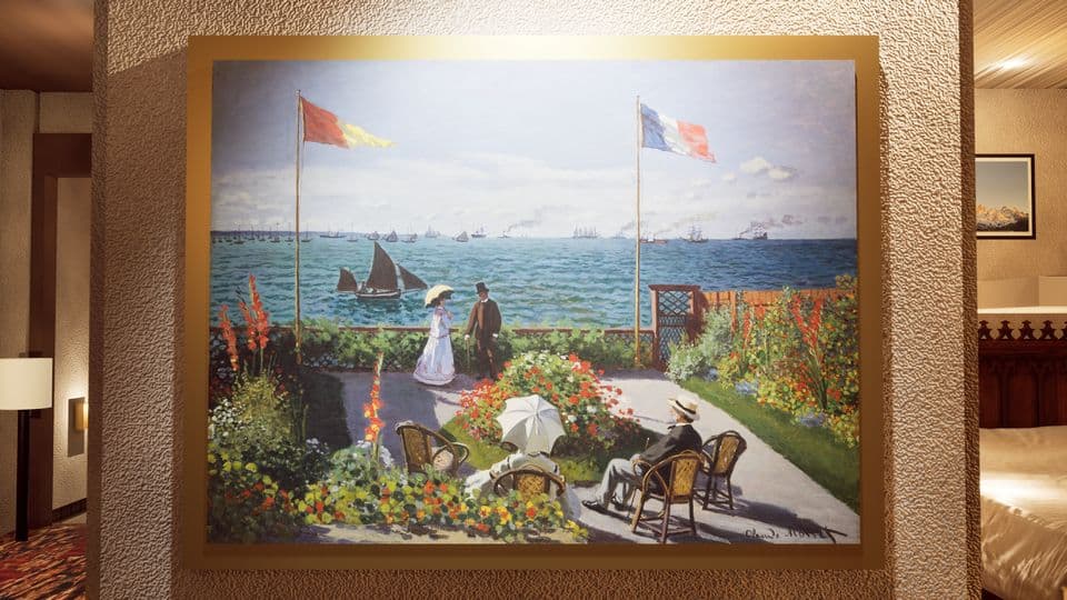 A framed Monet on the chalet wall, lit from above